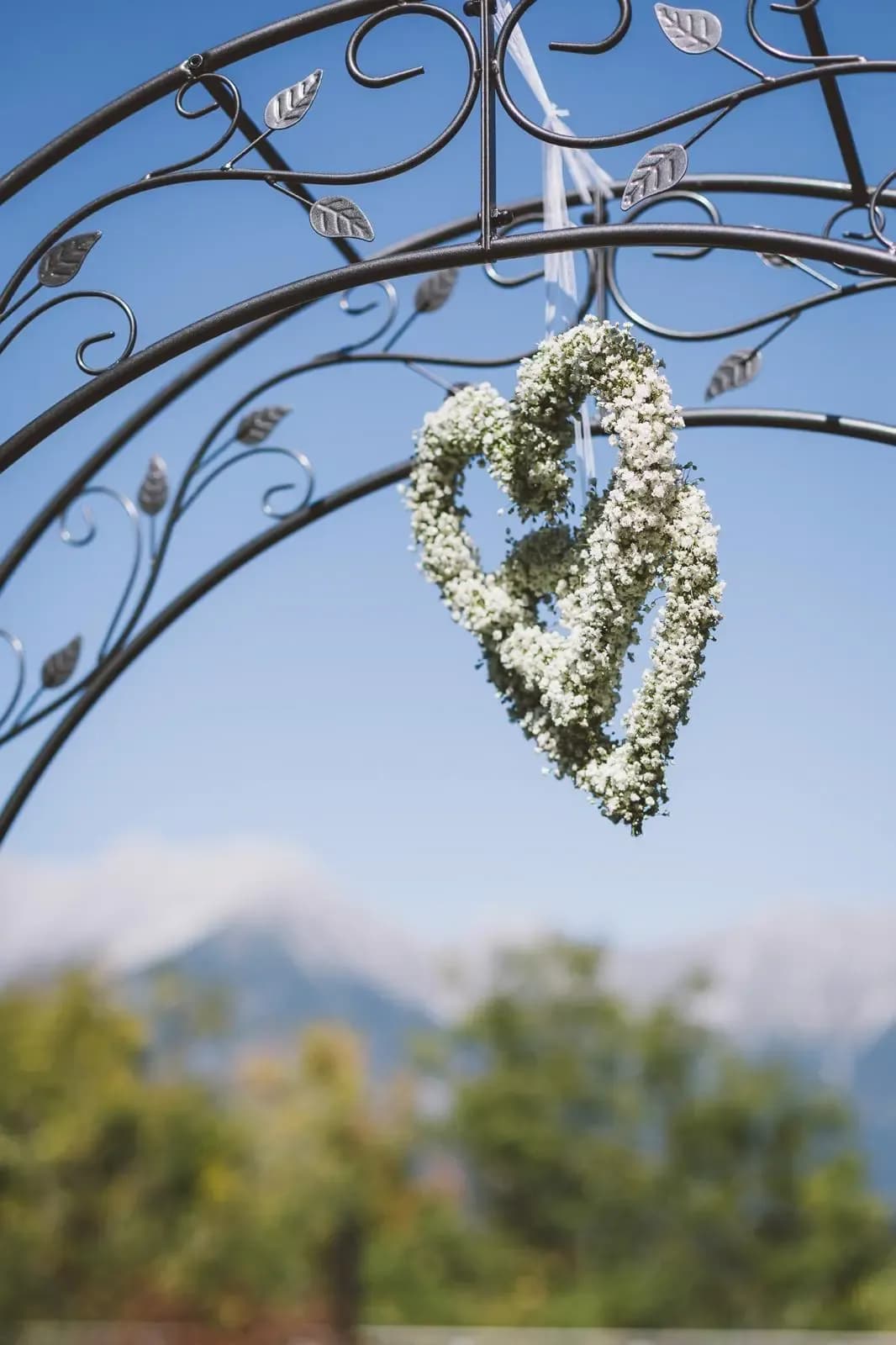 Blumen die vor Tiroler Bergkulisse bei Hochzeit hängen mit Traurednerin Rebekka